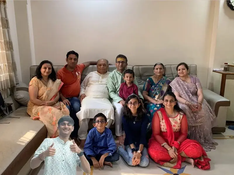Family group photo in a living room during a celebration