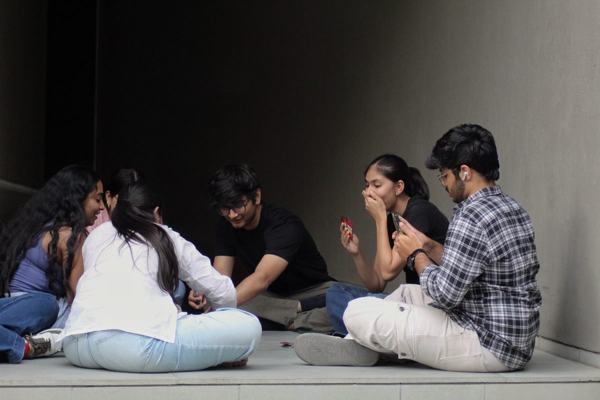 Friends sitting together on campus steps