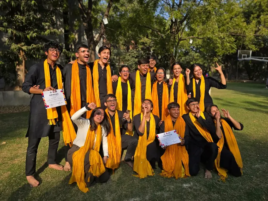 Theatre club group photo holding certificates in yellow scarves